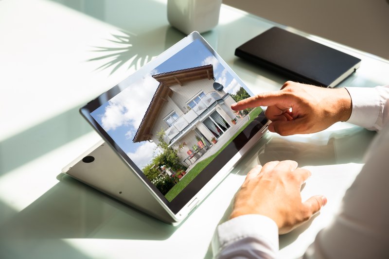 Someone looking at a house on a tablet