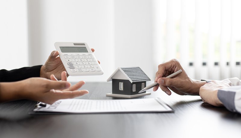 Two people exchanging a contract