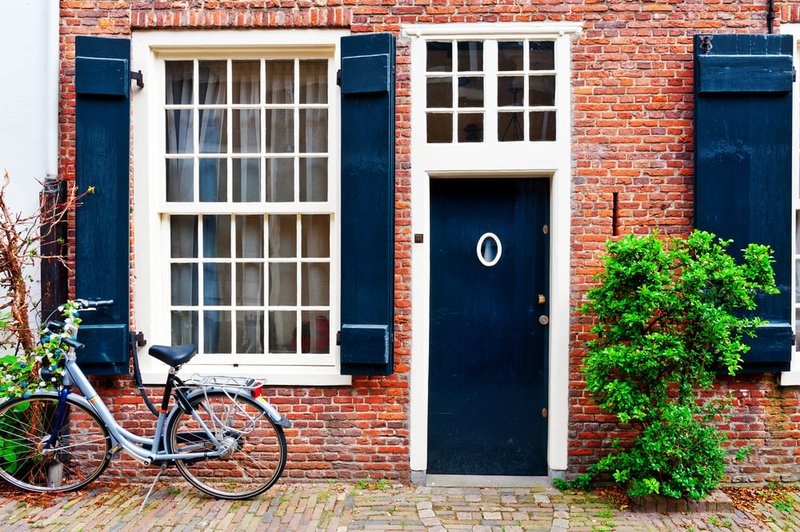 Black front door with a bike