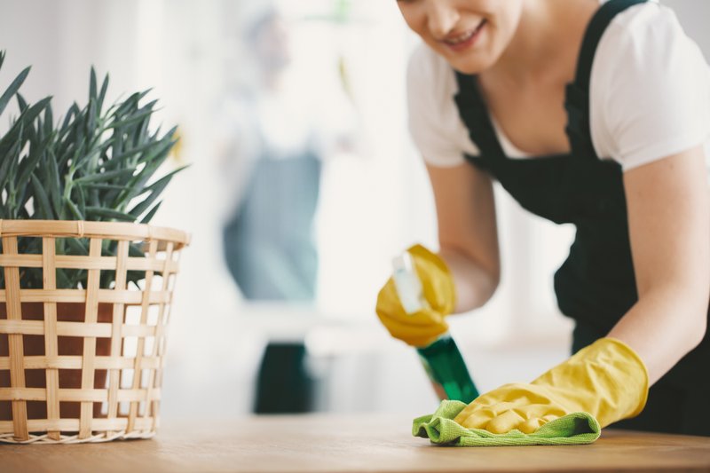 Someone cleaning a worktop